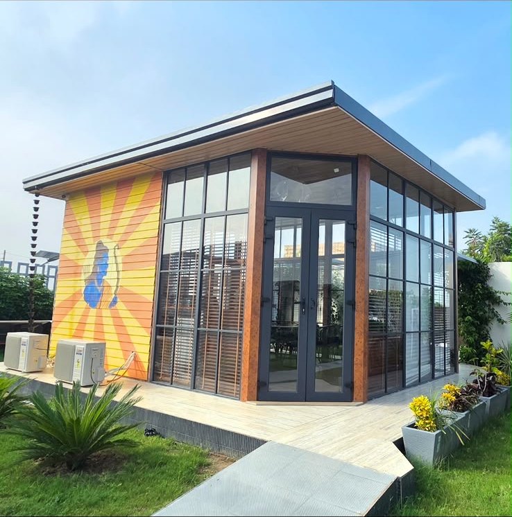 The glass-fronted cafe building with its painted sunburst mural